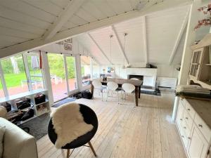een grote woonkamer met een tafel en stoelen bij Holiday Home Ninni - 3-2km from the sea in Sealand by Interhome in Eskebjerg