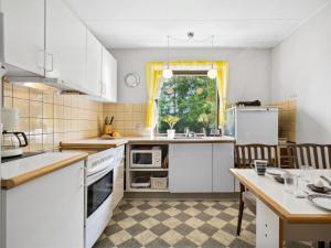 a kitchen with white appliances and a table with chairs at Holiday Home Magh - 9-8km from the sea in Western Jutland by Interhome in Tønder