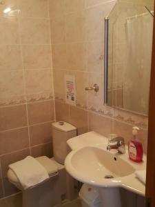 a bathroom with a sink and a toilet at Dolphin Apartments in Fethiye