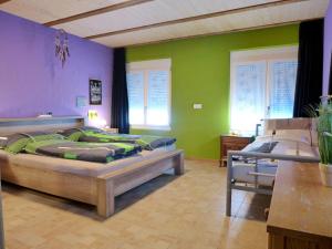 two beds in a room with green and purple walls at Apartment Tilia by Interhome in Bönigen