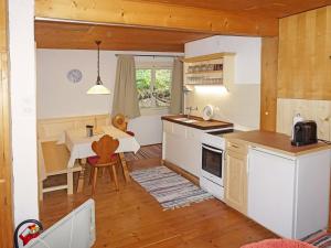 a kitchen with a table and a dining room at Chalet Lieblingsplatz by Interhome in Flirsch