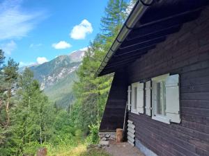a house with a window and mountains in the background at Chalet Lieblingsplatz by Interhome in Flirsch