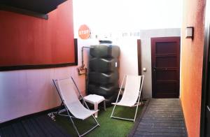 a group of chairs sitting in a room with a stop sign at Residential Majada Apartments in Puerto del Rosario