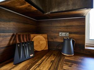 a corner of a kitchen with wooden walls and a knife block at Holiday Home Muhu by Interhome in Smržovka +29 photos