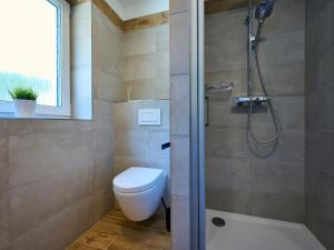 a bathroom with a toilet and a shower at Holiday Home Muhu by Interhome in Smržovka