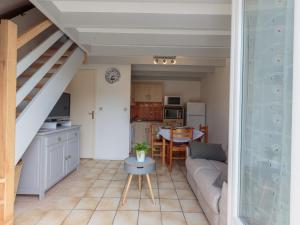 a living room with a couch and a table at Holiday Home Les Jardins de la Palmyre-2 by Interhome in Les Mathes +17 photos