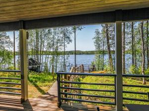a screened in porch with a view of a lake at Holiday Home Aurinkokaari by Interhome in Heinävesi