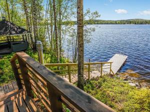 a wooden deck with a view of a lake at Holiday Home Aurinkokaari by Interhome in Heinävesi