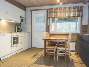 a kitchen with a table and chairs in a room at Holiday Home Aarakka 7 by Interhome in Sirkka