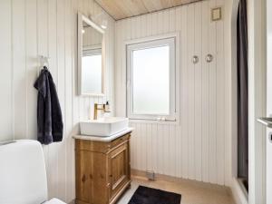a bathroom with a sink and a window at Holiday Home Neea - 280m from the sea by Interhome in Hadsund