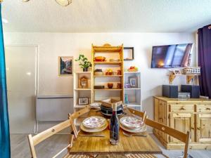 a room with a table with plates on it at Studio Soyouz Vanguard-99 by Interhome in Le Corbier