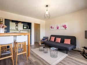 a living room with a couch and a bar at Studio Les Ecureuils-2 by Interhome in Les Mathes +15 photos