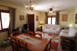 a living room with a table and a couch at Pineda - modern, well-equipped villa with private pool in Costa Blanca in Benissa