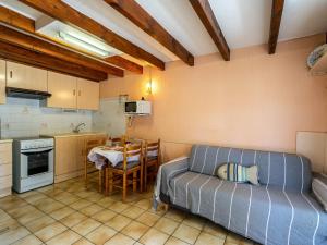 a kitchen with a couch and a table in a room at Holiday Home Les Jardins de la Palmyre-3 by Interhome in Les Mathes
