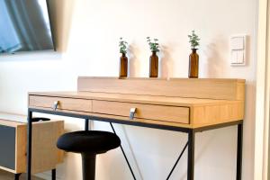 a desk with three bottles on top of it at Brandnew Modern Condo with Sauna in Rovaniemi