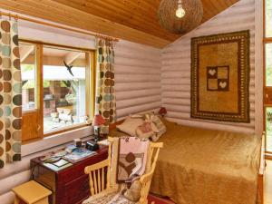 a room with a bed and a desk and a window at Holiday Home Jyrkänne by Interhome in Pyöli