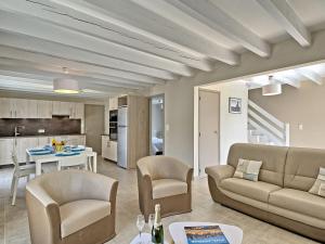 a living room with a couch and chairs and a table at Holiday Home Les Agapanthes by Interhome in Saint-Gildas-de-Rhuys +24 photos