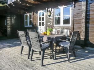 een eettafel en stoelen op een patio bij Chalet Xenia - TEM204 by Interhome in Vradal