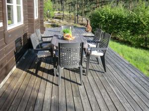 a patio with a table and chairs on a deck at Chalet Xenia - TEM204 by Interhome in Vradal