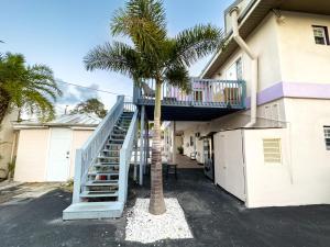 a staircase leading up to a building with a palm tree at Dream Home 10 Min To Beach W Shared Pool #21 in Clearwater