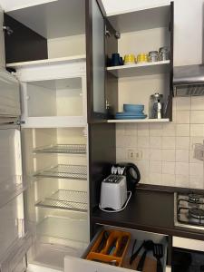 a refrigerator with its door open in a kitchen at HOME BIJOUX in Rho