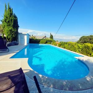 a swimming pool with blue water in a yard at Charming Villa Nika with the pool in Supetar