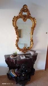 a mirror on top of a table in a room at Agriturismo Sant' Anna Ortì in Reggio di Calabria