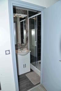 a bathroom with a sink and a glass shower at Eterlou in La Chambre