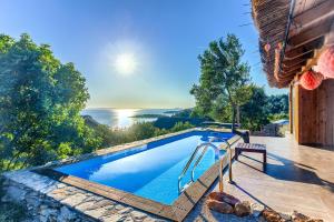 a pool in a villa with a view of the ocean at Lux Ii in Murter