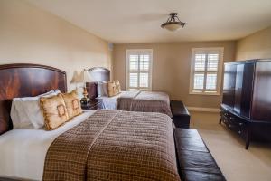 a hotel room with two beds and a television at Rawley Resort, Spa & Marina in Port Severn