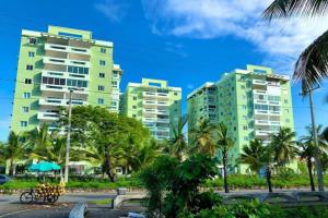 a group of tall buildings with palm trees at Charming Ocean View Apt Pool in La Francia