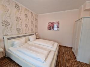 a small room with a bed with white sheets at H5 Hotel Bremen in Bremen