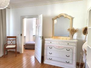 a white dresser with a mirror on top of it at Landhaus Domaine de Marie in Illingen