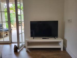 a flat screen tv on a white entertainment center in a living room at Landhaus Domaine de Marie in Illingen