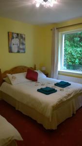 a bedroom with a bed with two towels on it at Mulberry Lodge B&B in Westport