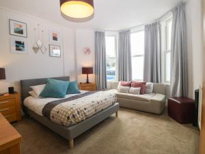 sypialnia z łóżkiem i kanapą w obiekcie Y Castell Apartment 1 w mieście Criccieth