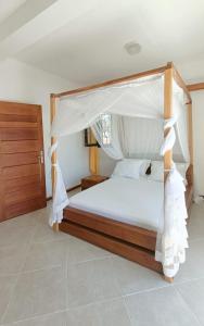 a bedroom with a bed with a canopy at BEL HORIZON Nosy Be in Nosy Be
