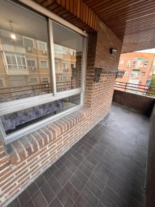 a window on a building with a brick wall at Mars Suites Alondra in Madrid