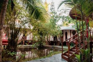 a view of a resort with a pond and trees at Eden Garden By Cliff Way in Varkala