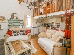 a living room with two couches and a table at The Orchard in Okehampton