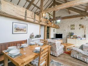 a dining room with a wooden table and chairs at The Orchard in Okehampton