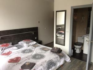 a bedroom with a large bed with a mirror at Eterlou in La Chambre