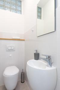 a white bathroom with a sink and a toilet at Villa Capra Verde in Ičići +26 photos