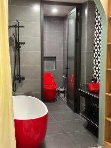 a bathroom with a red tub and a red toilet at A4 Home - Ha Long city Central in Ha Long