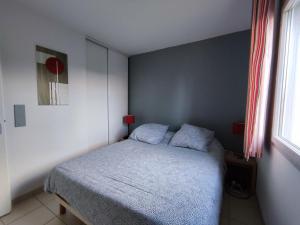 a small bedroom with a bed in a room at Résidence de la Source by Euclenima in Salies-de-Béarn