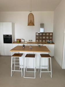 a kitchen with a wooden table and some chairs at Paradiso sul mare in Santa Cesarea Terme