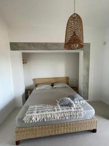 a bedroom with a large bed with a wicker headboard at Paradiso sul mare in Santa Cesarea Terme