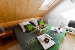 a large bed in a room with a wooden ceiling at Chalet Like Upstairs Private Suite in Étiolles