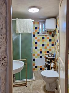 a bathroom with a toilet and a sink at Residenza Anima Mediterranea in Francavilla Fontana +40 photos