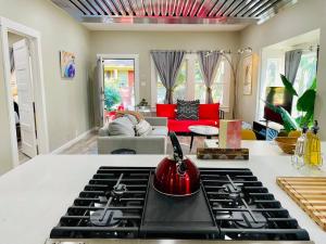 a kitchen with a stove top in a living room at Artists Bungalow ARCADE King Beds near the beat in Sacramento